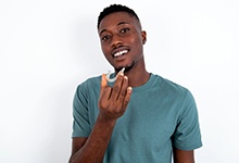 Teen patient in San Antonio smiling with Invisalign Teen
