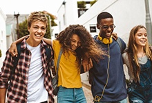 Invisalign Teen patient in San Antonio smiling with friends