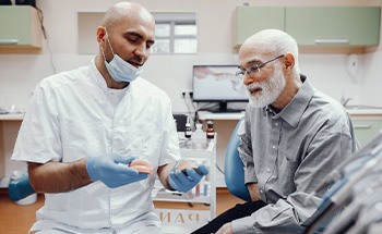 Patient in San Antonio talking to dentist about dentures alternatives