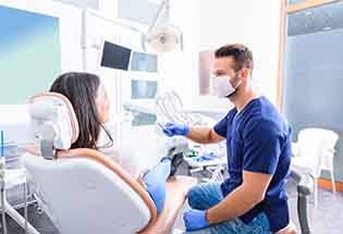 Dentist and patient talking in dental office