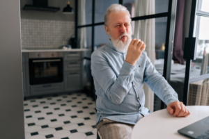 Mature adult looks displeased because his food tastes weird